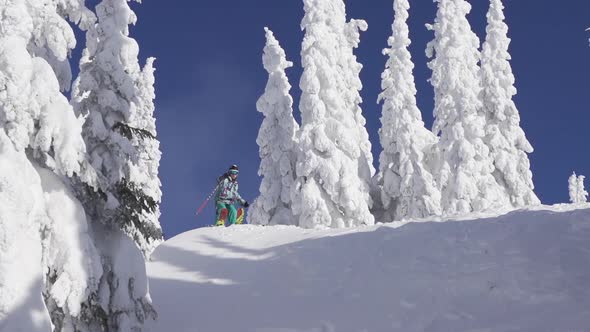 A man skiing down a snow-covered mountain in the winter.