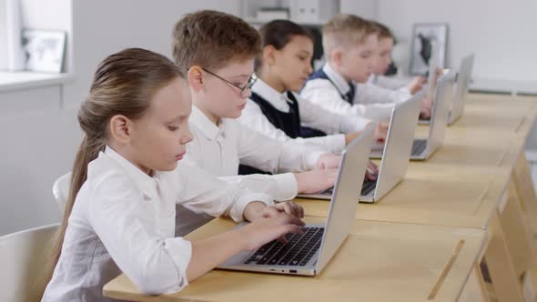 Preteen Caucasian Girl Smiling in Computer Education Class