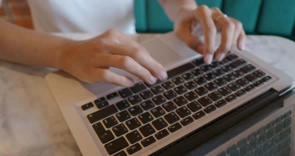 Woman Works Remotely in Cafe with Red Brick Walls