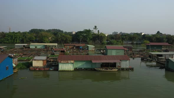 Slow tracking drone shot along floating fish farming community in Bien Hoa on the Dong Nai river, Vi