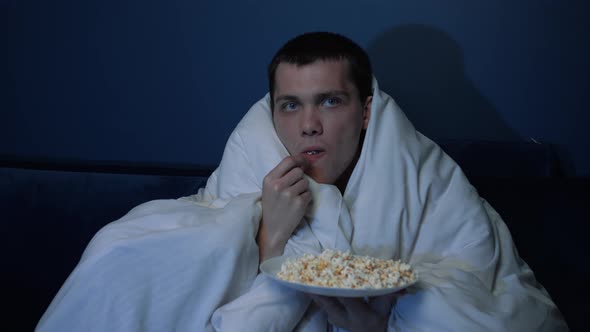 Shocked Handsome Caucasian Man Watches TV Movie Blanket Evening Eats Popcorn Sofa Home He Is Very