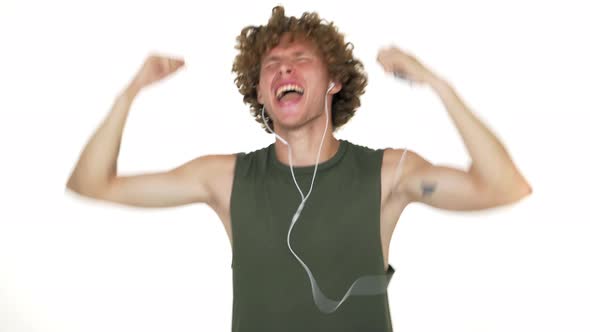 Happy Energetic Guy Emotionaly Listening to Favourite Music on Mobile Via Headphones Dancing Smiling