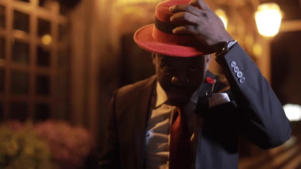African Businessman Clothe Red Hat in the Night City