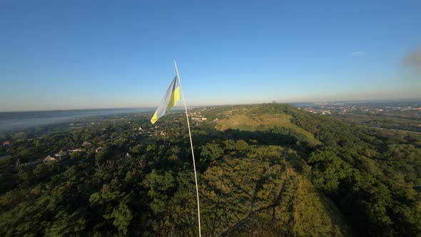 FPV Drone View Flight Around the Ukrainian Flag on DivychHora at Dawn