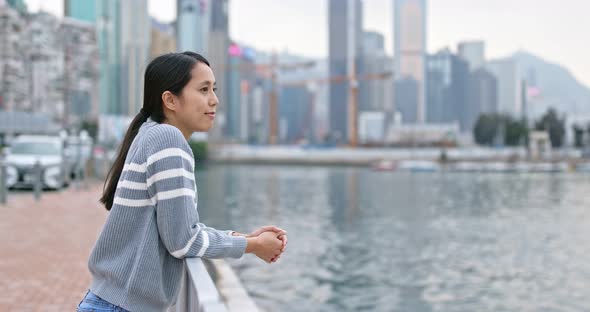 Woman look at the sea in the city