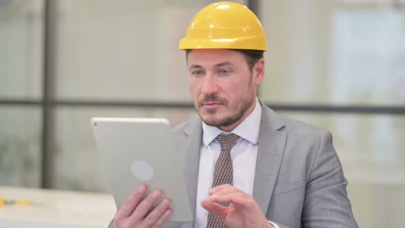 Portrait of Attractive Middle Aged Engineer using Tablet in Office