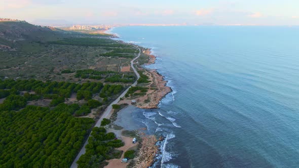 Ocean Coast Waves Crashing On Countryside Shore Near Road In Santa Pola, Spain.