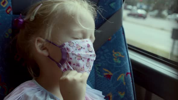 Small Girl Traveller Yawning in a Mask