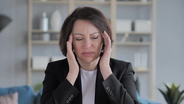 Portrait of Old Businesswoman Gesturing Headache Stress