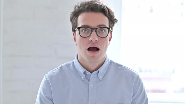 Portrait of Surprised Young Man in Shock
