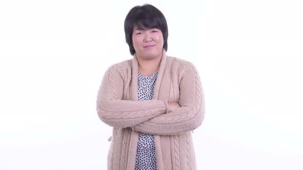 Happy Overweight Asian Woman Smiling with Arms Crossed Ready for Winter