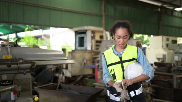 Female chief mechanic works in a mechanical factory