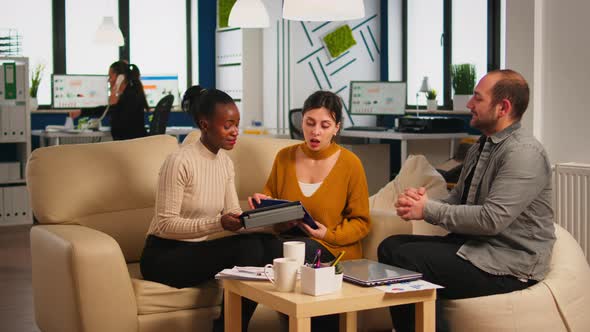 Black Businesswomen Shaking Hands with Manager Sitting on Couch