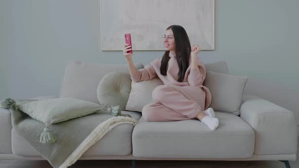 Young Caucasian woman making online video call from mobile device. Long distance communication