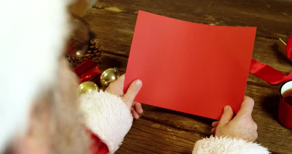 Santa claus holding a blank christmas card 4k