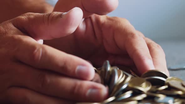 Gold and Silver Coins in Hand