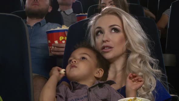 Mother Watching Film In Cinema With Children, Close Up