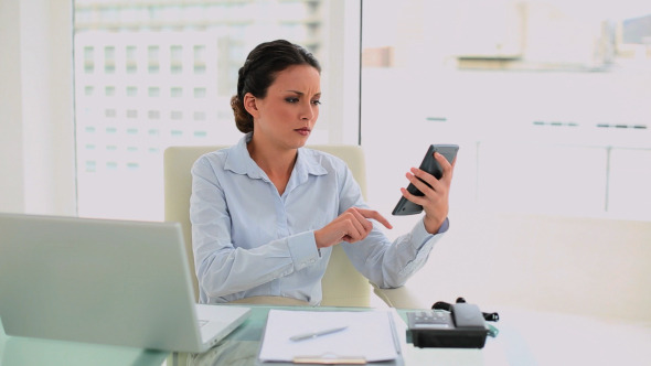 Worried Businesswoman Making Calculations