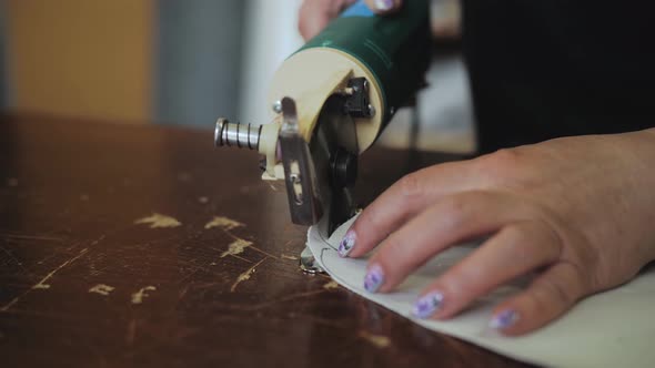 An Female Worker Cutting Foam Rubber for the Production of a Sofa in a Furniture Factory Closeup