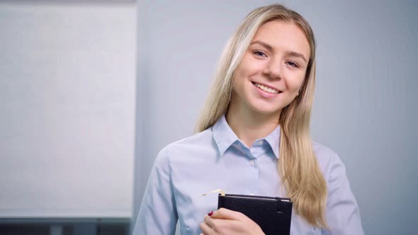 Portrait of Successful European Business Woman Office Worker Holding Notepad