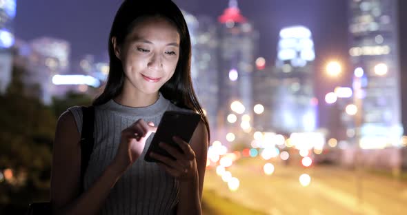 Woman use of mobile phone at night 