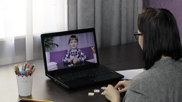 Woman Teacher Making Video Call on Laptop with Little Pupil. Distance Education