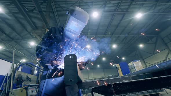 Male Specialist, Welder Starts Welding Metal with a Cutting Machine