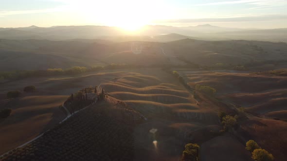 Val d'Orcia Valley Farmhouse, Cypress Trees and Rolling Hills Tuscany Aerial at Sunset Autumn