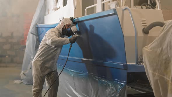 Workman Spraying Paint on Boat