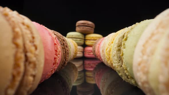 Colored Macaroons Confectionery Marshmallows on a Black Reflective Background in Perspective