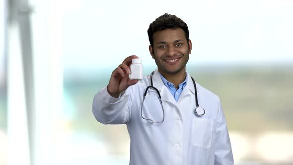 Young Smiling Doctor Recommending Pills.