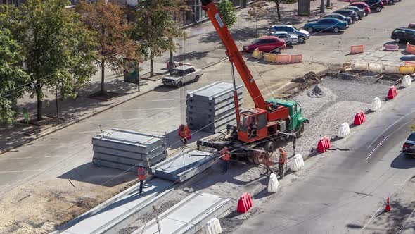 Installing Concrete Plates By Crane at Road Construction Site Timelapse