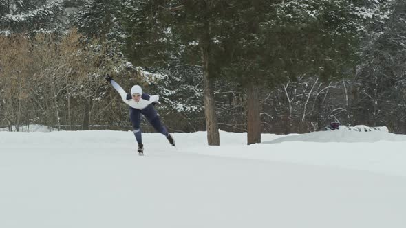 Speed Skaters Sprinting in Outdoor Ice Rink