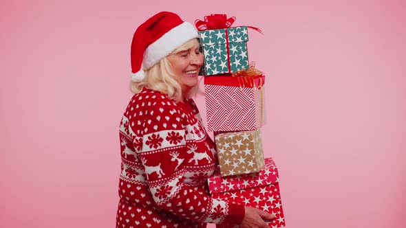 Mature Grandmother Woman in Christmas Sweater Holding Many Gift Boxes New Year Present Shopping Sale