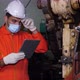 maintenance worker or engineer using digital tablet, wiping sweat, inspecting. - VideoHive Item for Sale