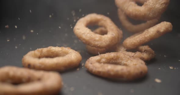 Onion rings close up slow motion studio, tasty fast food