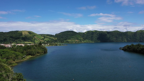 Volcanic crater with blue lake inside. Aerial drone top down flight over, Azores, 4k.