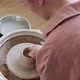 Female Potter Sitting and Makes a Cup on the Pottery Wheel. Woman Making Ceramic Item. Pottery - VideoHive Item for Sale