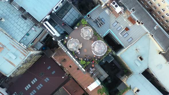 Topdown aerial drone of a rooftop bubble restaurant in Lviv Ukraine surrounded by old European build