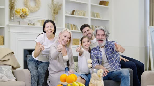 Big Happy Family Talking By Video Call or Taking Selfie While Sitting on Sofa at Home