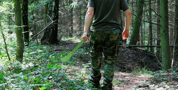 Man With Machete In Forest