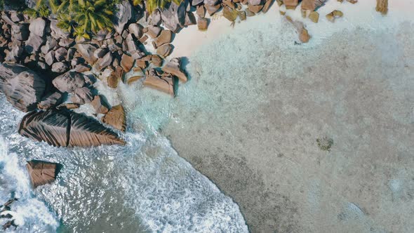 Aerial View Vertical Footage of Crystal Clear Turquoise Shallow Water and Amazing Granite Rocks on