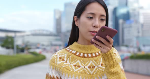 Woman work on mobile phone in city