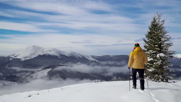 A Man Travels in the Mountains in Winter