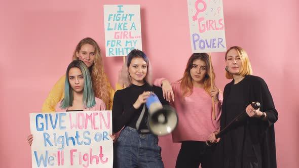 Feminism Concept. Five Young Girls Feminists Advocating Feminism Isolated Over Pink Background