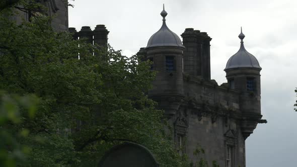 Tree branches and the turrets of a castle tower