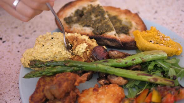 Close Up of Vegan Lunch of Tofu Omelette Asparagus Hummus Toast and Grilled Vegetables