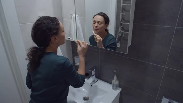 Beautiful Black Woman Cleaning Mouth with Natural Bamboo Eco Brush