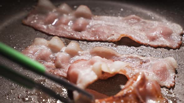 Closeup of a Slice of Bacon Fried on a Hot Grill