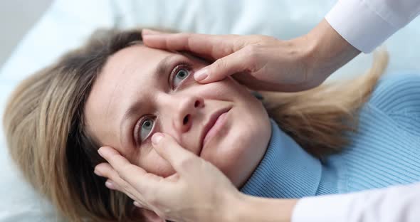 Doctor Examining Eyes of Sick Female Patient in Clinic  Movie Slow Motion